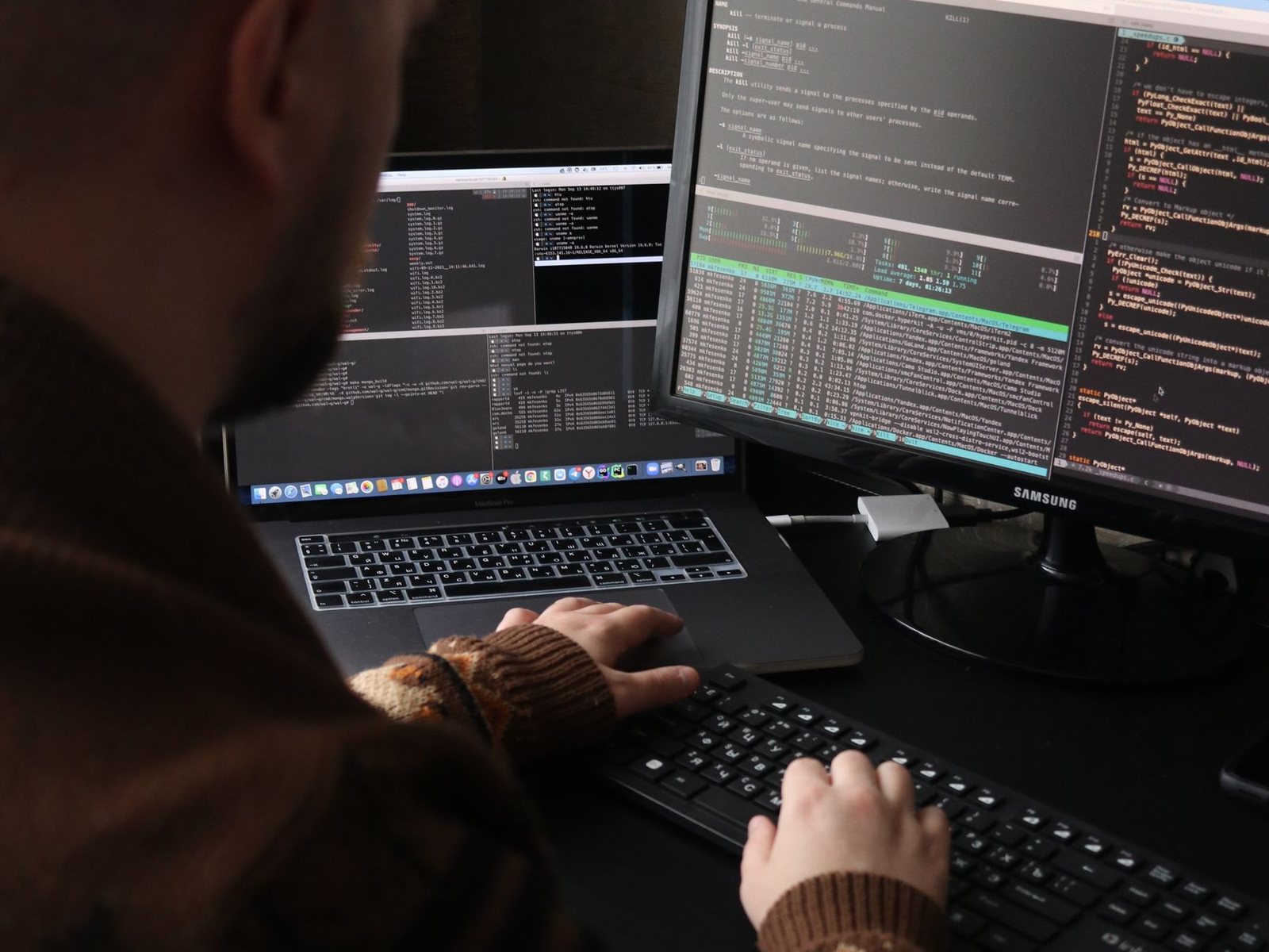ALIFY engineer shipping production code on dual monitors in a dim studio